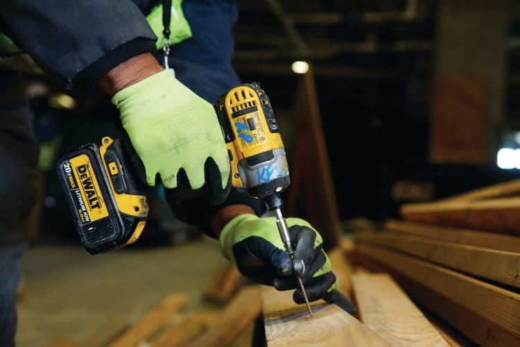 Hand using a drill; learn what are the most in-demand jobs for skilled trades professionals